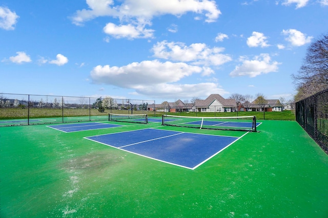 view of sport court featuring fence
