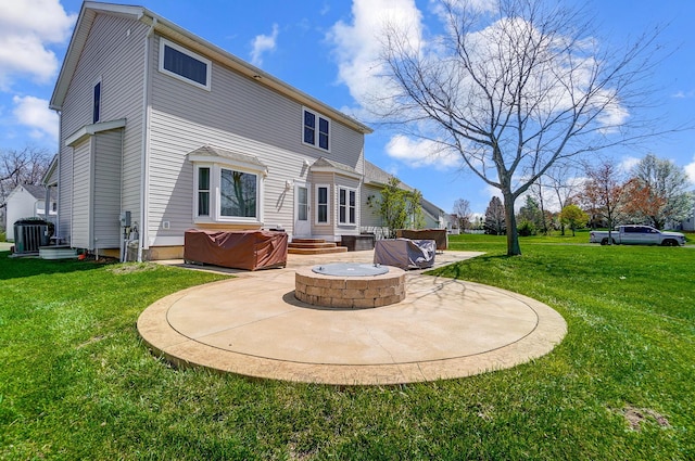 rear view of property featuring a yard, central air condition unit, and a patio