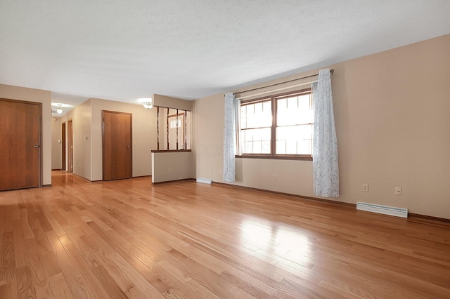 unfurnished living room featuring light wood-style flooring, baseboards, and visible vents
