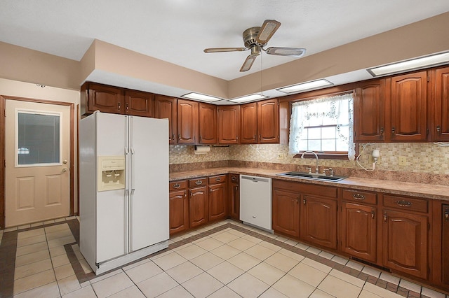 kitchen with tasteful backsplash, light tile patterned floors, a sink, a ceiling fan, and white appliances