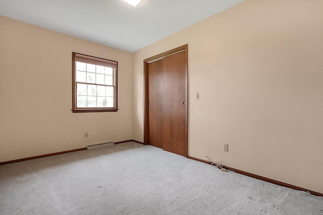 unfurnished room featuring carpet, visible vents, and baseboards