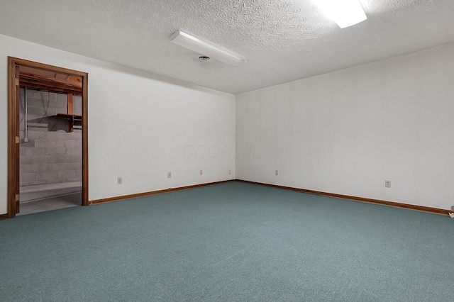 spare room with baseboards and carpet floors