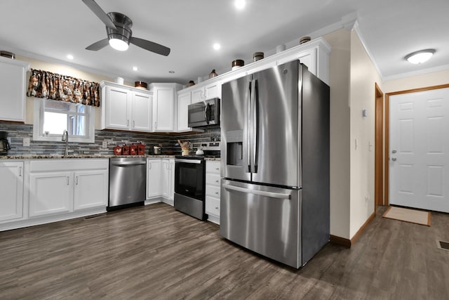 191 Craig Dr, Thornville, OH 43076 - kitchen with dark wood-type flooring, white cabinetry, ornamental molding, appliances with stainless steel finishes, and a sink