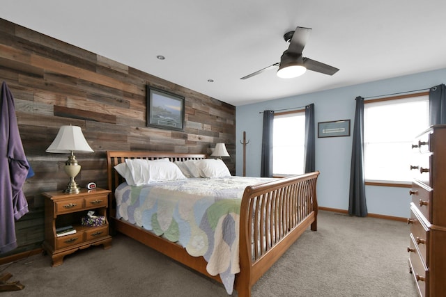 191 Craig Dr, Thornville, OH 43076 - bedroom with baseboards, an accent wall, a ceiling fan, wooden walls, and carpet flooring