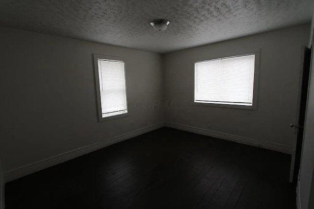empty room with baseboards and a healthy amount of sunlight