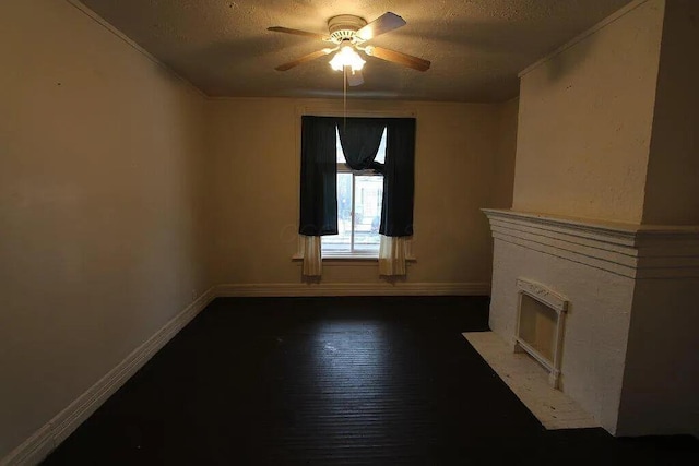 unfurnished living room featuring a fireplace with flush hearth, a textured ceiling, ceiling fan, and baseboards
