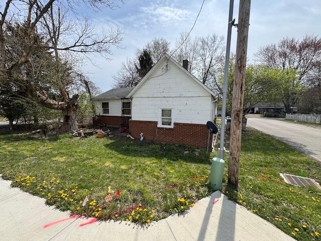 6927 Rings Rd, Dublin, OH 43016 - view of property exterior with brick siding, a chimney, and a lawn