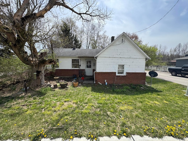 6927 Rings Rd, Dublin, OH 43016 - view of home's exterior featuring brick siding, fence, and a lawn