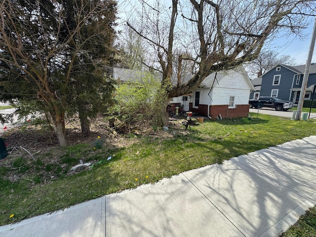 6927 Rings Rd, Dublin, OH 43016 - view of property exterior with brick siding and a lawn