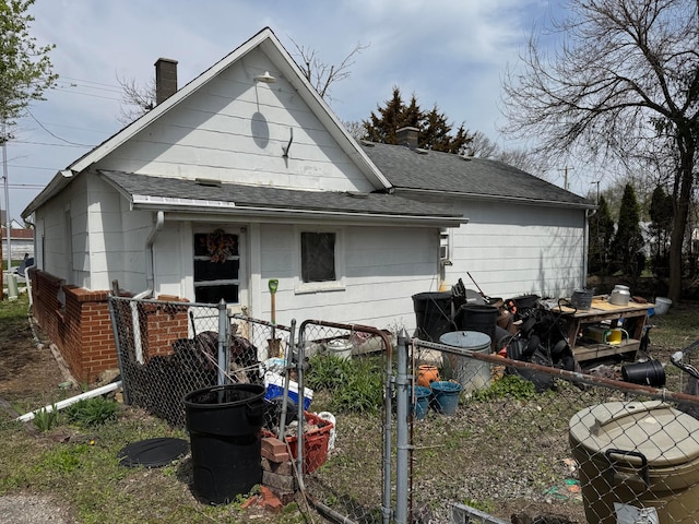 6927 Rings Rd, Dublin, OH 43016 - back of house with roof with shingles, fence, and a chimney