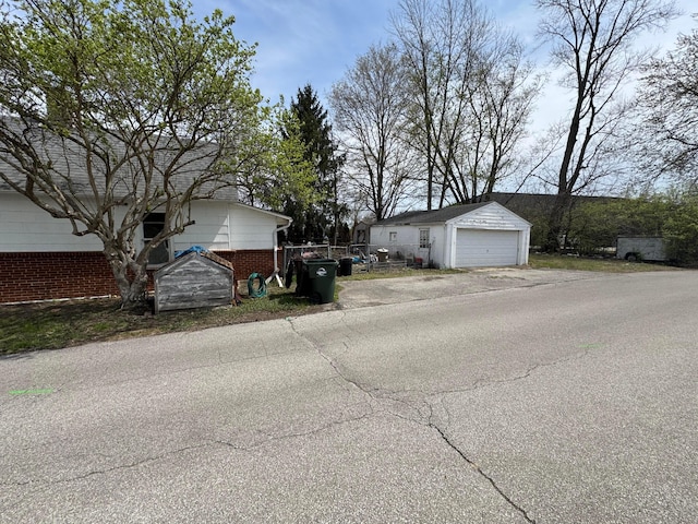 6927 Rings Rd, Dublin, OH 43016 - view of side of property featuring a detached garage and an outdoor structure