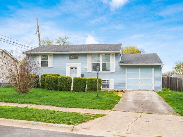 3198 Benham Ct, Columbus, OH 43232 - bi-level home featuring a garage, driveway, a front lawn, and fence