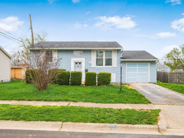3198 Benham Ct, Columbus, OH 43232 - split foyer home with an attached garage, a front yard, fence, and aphalt driveway