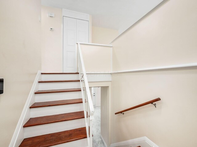 3198 Benham Ct, Columbus, OH 43232 - stairway featuring baseboards and carpet floors