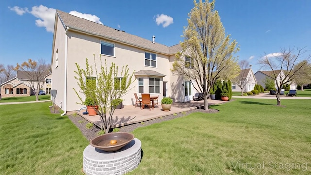 8510 Morgan St, Pickerington, OH 43147 - rear view of property featuring a patio, stucco siding, and a lawn