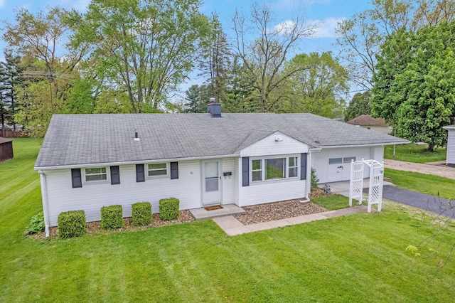 ranch-style house featuring a front lawn, driveway, and a garage