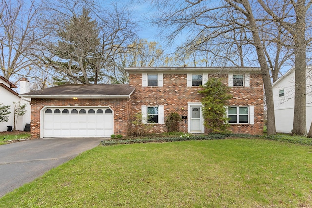 1091 Matterhorn Dr, Reynoldsburg, OH 43068 - colonial inspired home with aphalt driveway, brick siding, an attached garage, and a front yard