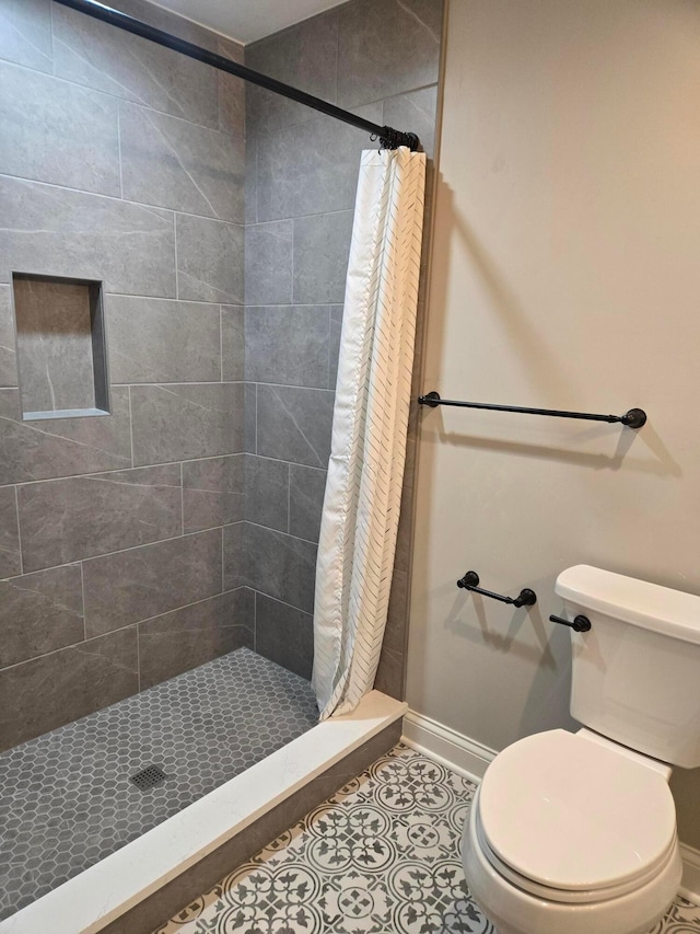 2372 Linden St, Lewis Center, OH 43035 - bathroom with baseboards, tile patterned flooring, toilet, and a shower stall