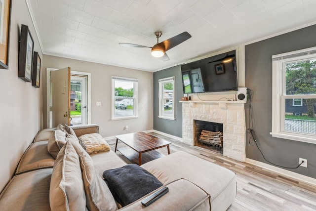 1329 Studer Ave, Columbus, OH 43206 - living area featuring plenty of natural light, a ceiling fan, wood finished floors, a fireplace, and ornamental molding