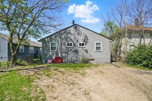 rear view of house with fence
