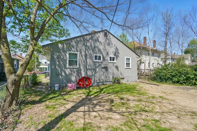 back of property featuring fence