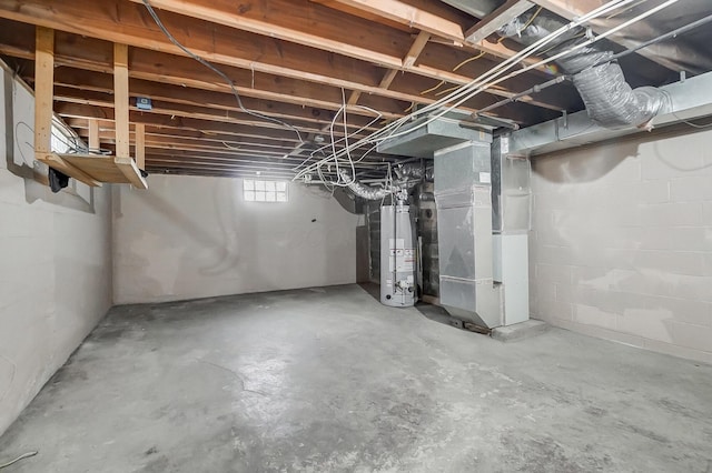 basement featuring heating unit and water heater