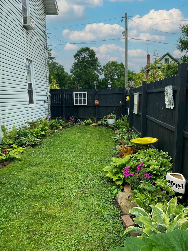 view of yard featuring cooling unit and a fenced backyard