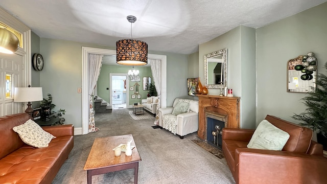 carpeted living area with a fireplace with flush hearth and stairway