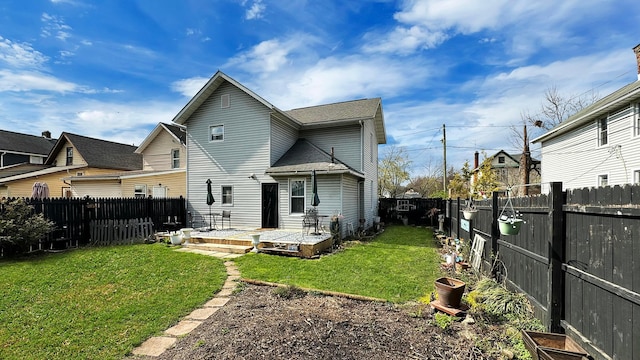 back of house featuring a yard, a fenced backyard, and a wooden deck