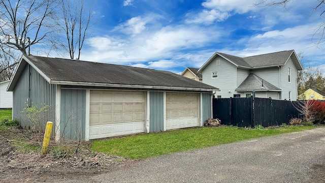 detached garage featuring fence