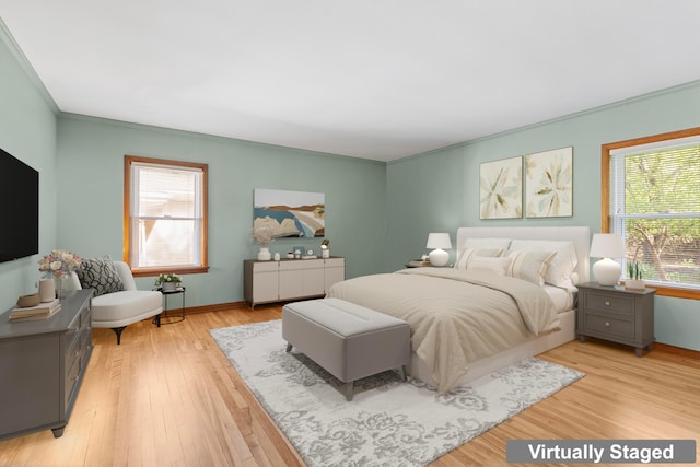 bedroom with light wood-type flooring, baseboards, and crown molding