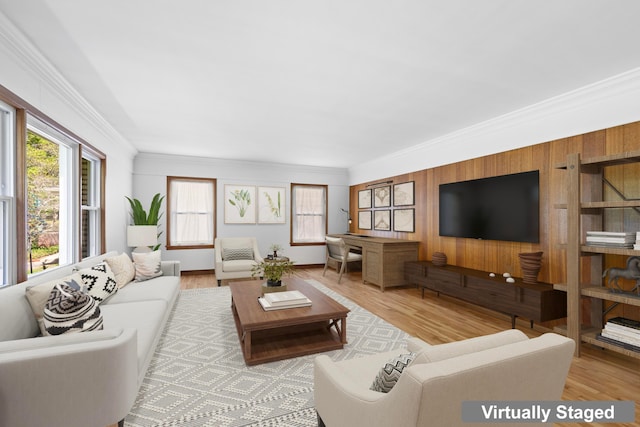 living area featuring crown molding, a wealth of natural light, and wood finished floors