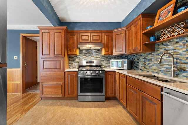 kitchen with open shelves, a sink, light countertops, stainless steel appliances, and under cabinet range hood