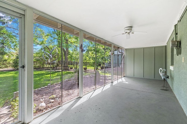 unfurnished sunroom featuring a ceiling fan