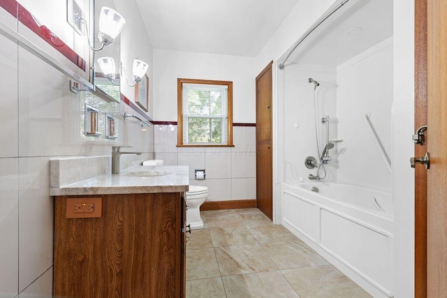 bathroom featuring tile walls, tile patterned flooring, vanity, toilet, and  shower combination