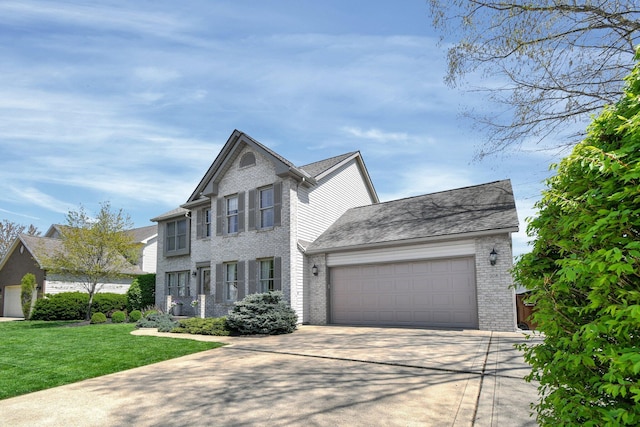 208 Kildare St, Granville, OH 43023 - view of front of property with an attached garage, brick siding, driveway, and a front yard