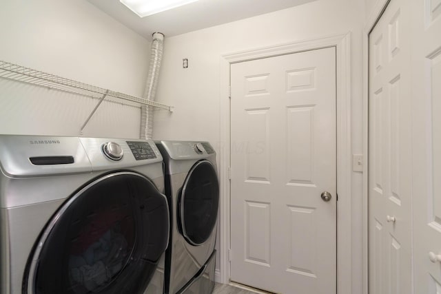 clothes washing area featuring laundry area and washing machine and clothes dryer