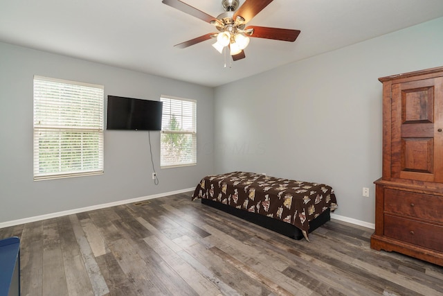 bedroom with baseboards, a ceiling fan, and wood finished floors