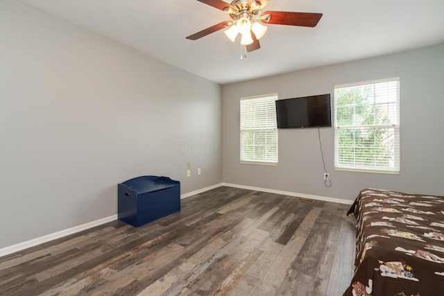 unfurnished bedroom featuring baseboards, ceiling fan, and wood finished floors