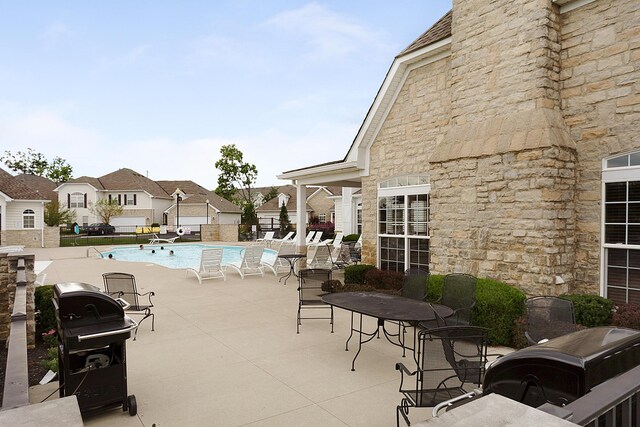 view of patio / terrace with grilling area and a community pool