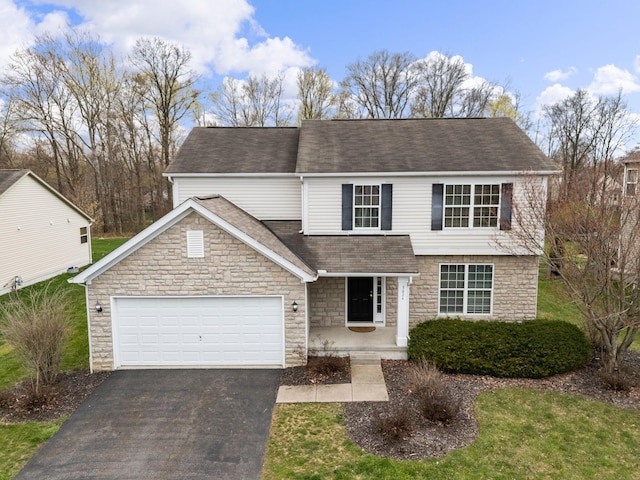 traditional-style house with a shingled roof, stone siding, a garage, and aphalt driveway