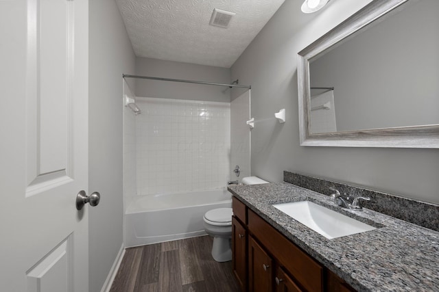 full bath with visible vents, toilet, a textured ceiling, vanity, and wood finished floors