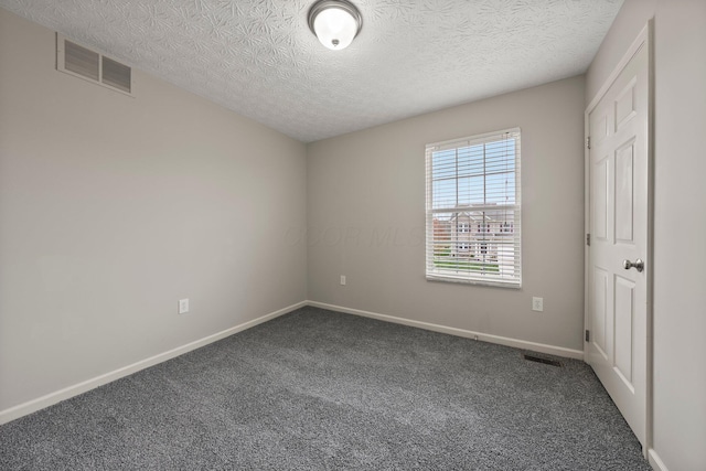 unfurnished bedroom featuring a textured ceiling, baseboards, carpet, and visible vents