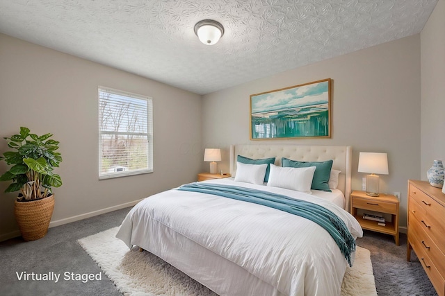 bedroom featuring carpet, baseboards, and a textured ceiling