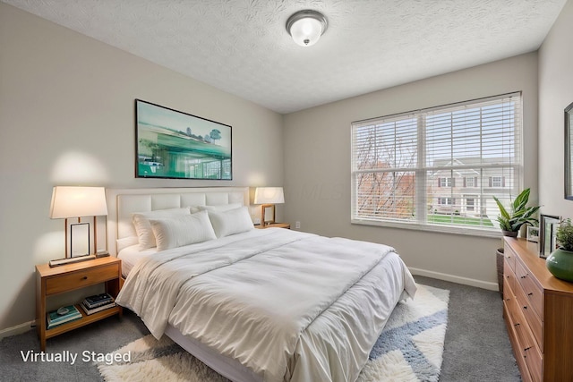 bedroom with dark carpet, baseboards, and a textured ceiling