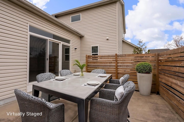 view of patio / terrace with outdoor dining space and fence