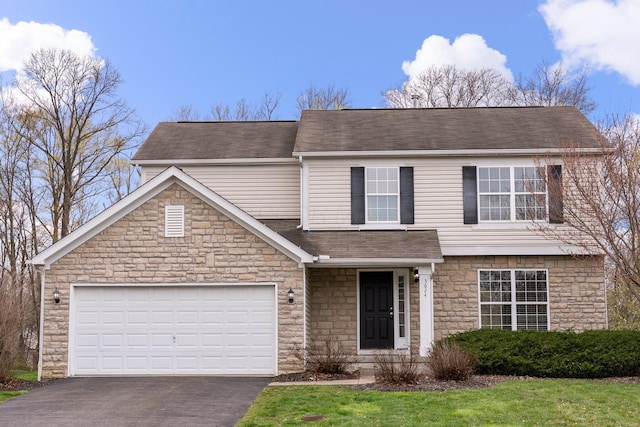 traditional home featuring an attached garage, a shingled roof, stone siding, and driveway