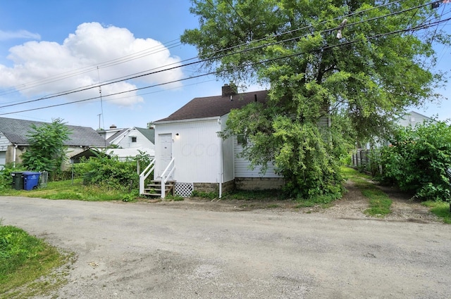 1287 E 19th Ave, Columbus, OH 43211 - view of property exterior featuring a chimney and a shingled roof