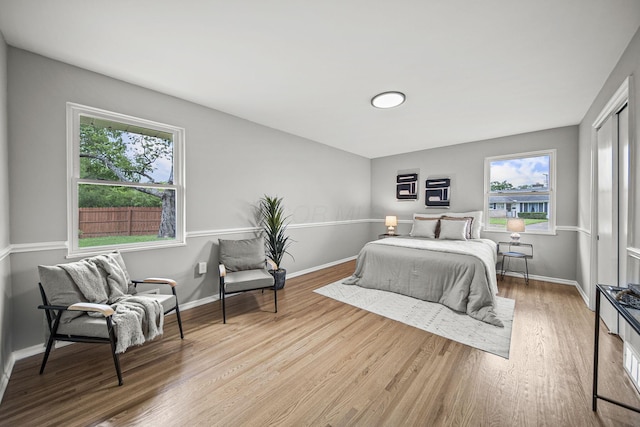 2960 Berwick Blvd, Columbus, OH 43209 - bedroom with multiple windows, wood finished floors, and baseboards