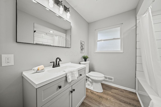2960 Berwick Blvd, Columbus, OH 43209 - full bathroom with toilet, wood finished floors, vanity, and baseboards